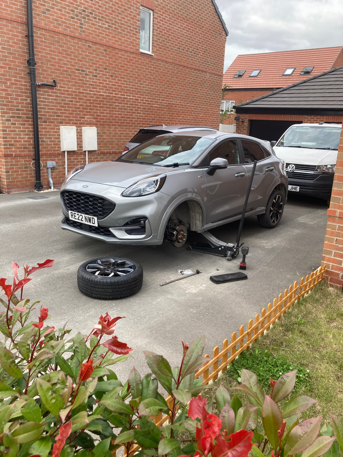 Alloy wheel change on a silver Ford Puma on a home driveway