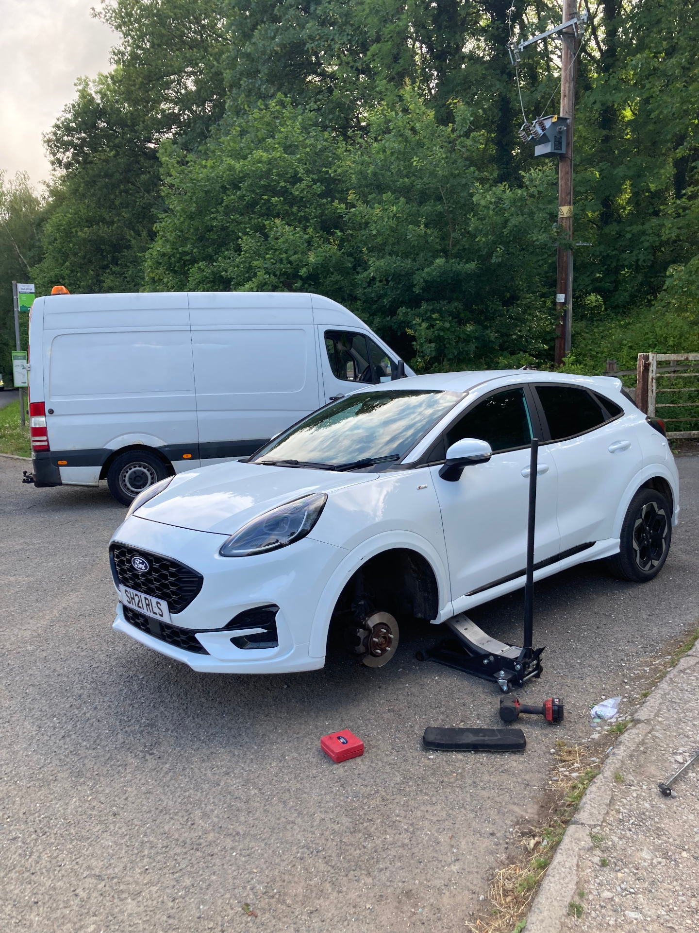 Mobile tyre replacement on a white Ford Puma at the roadside